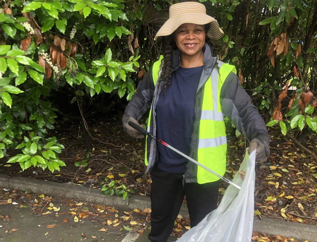 josephine picking up litter and placing it in a bin